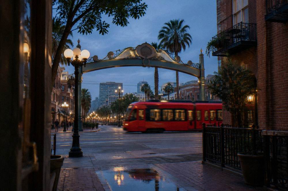 A downtown archway sign lit in the early evening