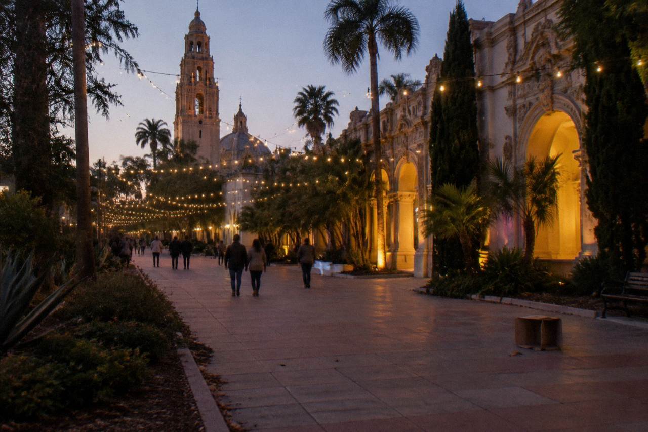 Festival string lights glowing above a garden promenade at dusk