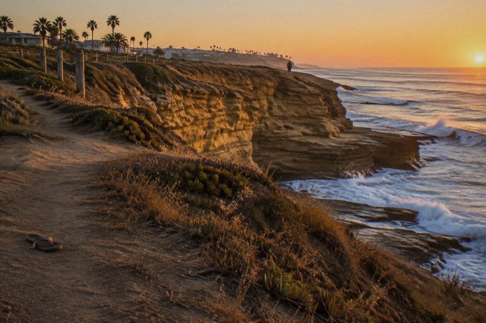 Sandstone cliffs along the Sunset Cliffs shoreline at golden hour
