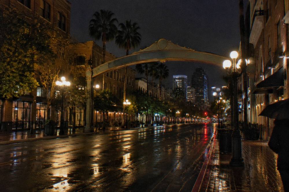 The Gaslamp Quarter sign arch spanning Fifth Avenue above evening streetlights