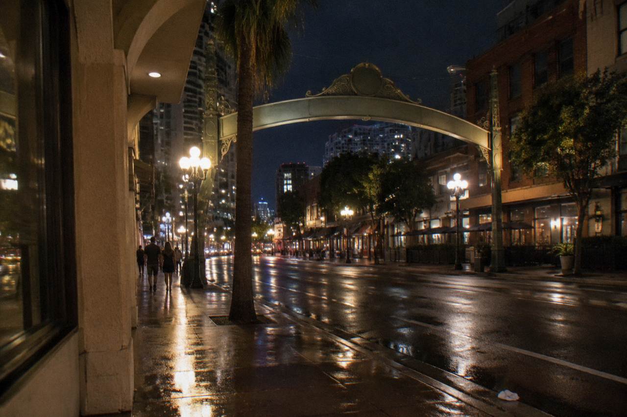 The Gaslamp Quarter sign arch glowing above Fifth Avenue in the evening