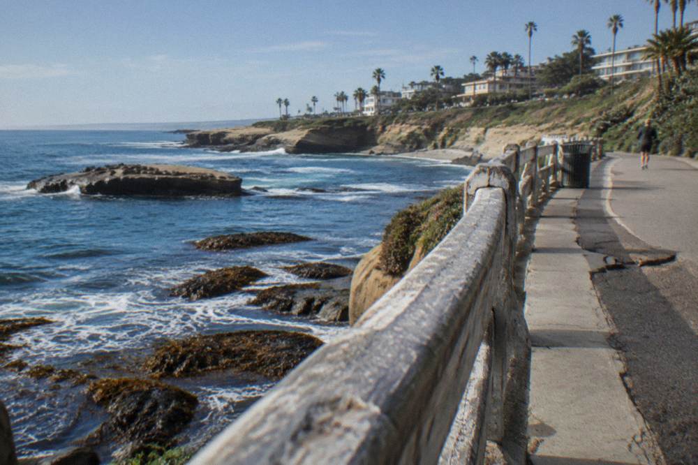 A coastal path along the top of cliffs with ocean water below