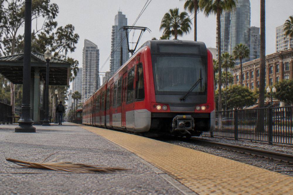 A city trolley waiting at an outdoor station platform