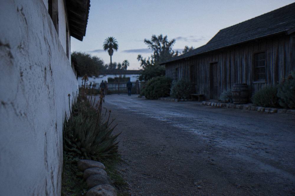 Historic wooden and adobe buildings along a quiet street in Old Town San Diego