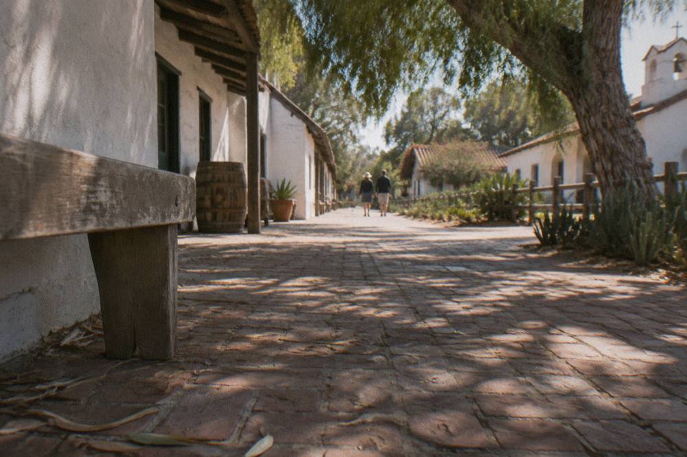 Old Town San Diego plaza with white adobe buildings and shaded walkways