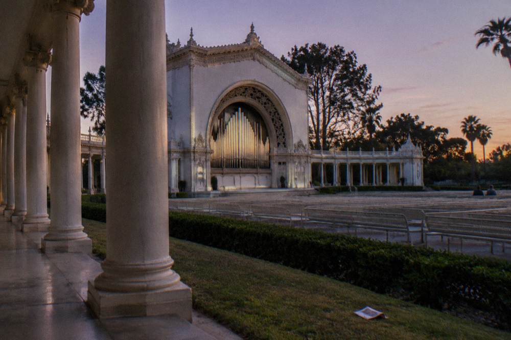 Organ pipes and open pavilion seating lit for an evening concert