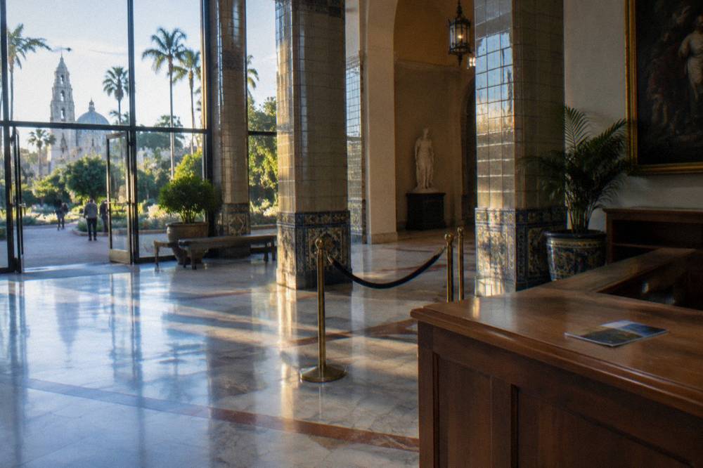 An empty museum lobby with an admission desk and tiled pillars