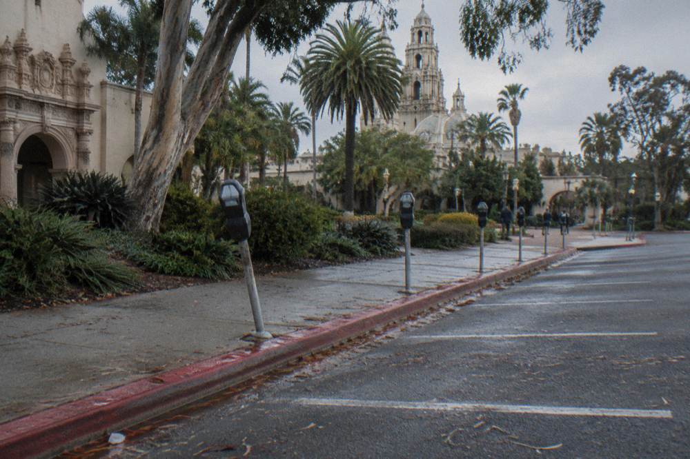 Empty metered parking spaces on a Balboa Park street in morning light