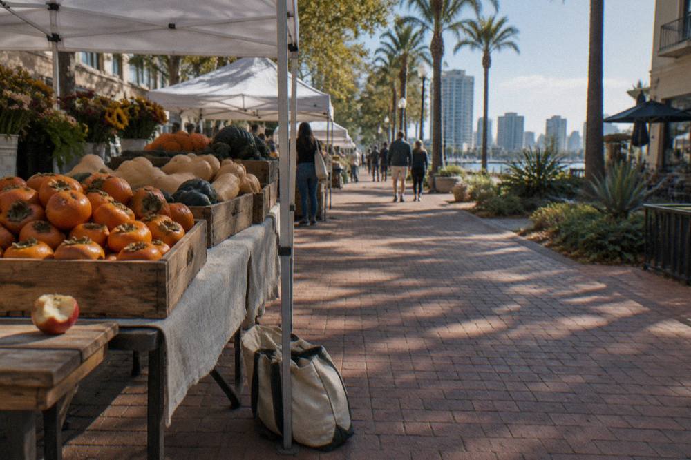 A farmers market stall with autumn produce arranged under a canopy