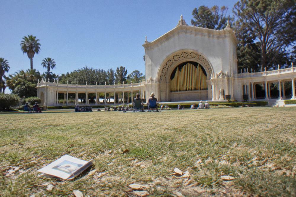 An outdoor pipe organ pavilion seen across an open lawn