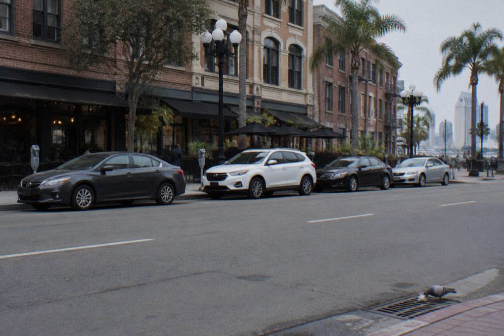 Row of parked cars and parking meters on a downtown San Diego street