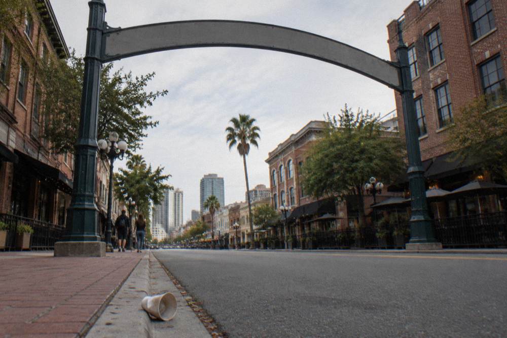 Gaslamp Quarter arch sign above a downtown street with the sidewalk below