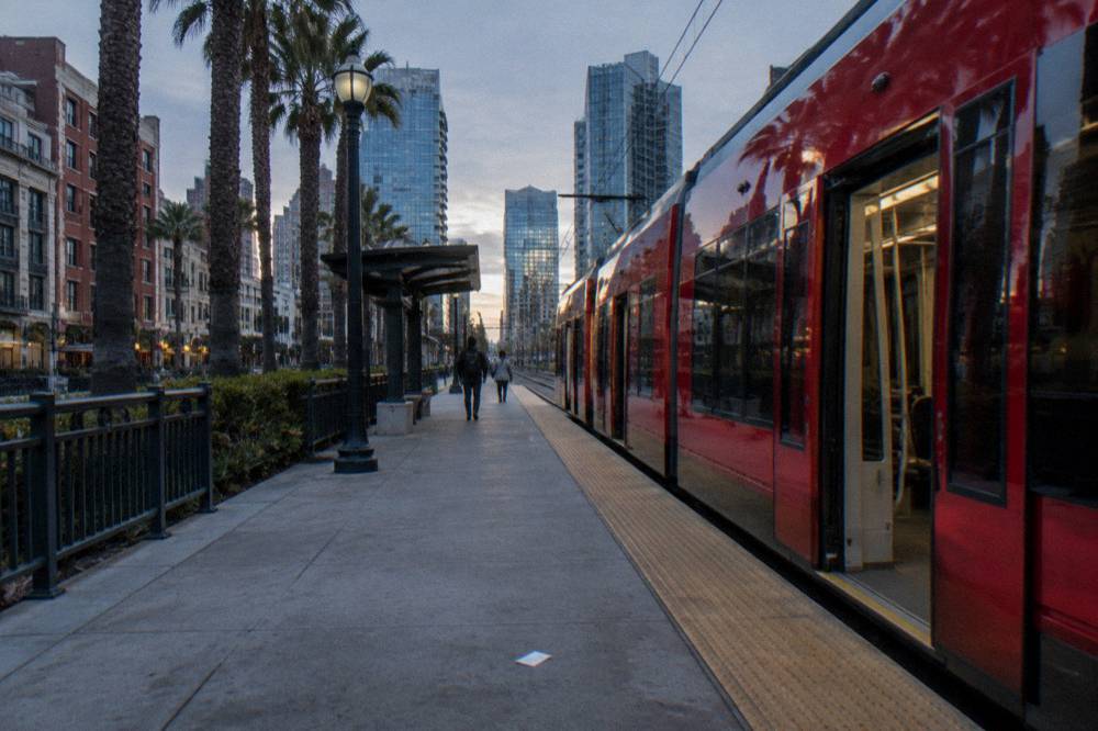 Trolley station platform beside downtown San Diego buildings