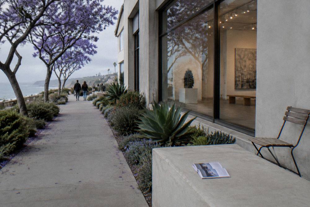 A village street frontage with gallery windows and planted sidewalks