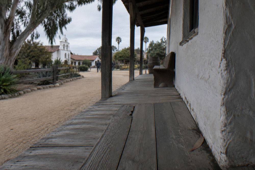 Historic adobe building with wooden porch in Old Town San Diego